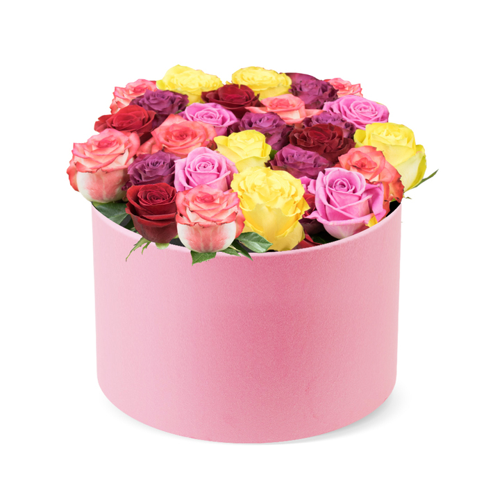 A romantic, elegant creation from Notting Hill, this soft-pink round hat box rests against a crisp white backdrop. The velvet-like cylinder opens to reveal a lush dome of thirty to forty roses, arranged with care to spill gently from the box. The palette runs from sunny yellow and bright coral pink to deep red and burgundy, with pinks ranging from soft blush to vibrant magenta, and touches of cream and purple-plum. Green leaves provide natural contrast, peeking between the blooms. Each rose is perfectly bloomed, a sign of premium quality and craftsmanship. The overall effect is timeless romance and sophisticated celebration, ideal for Valentine's Day, anniversaries, or milestone birthdays, and a stylish statement in any Notting Hill home near Holland Park Avenue or Westbourne Grove. Delivered with reliable care to Notting Hill and surrounding districts, the arrangement reflects the skill of a seasoned local florist and the character of the area's boutique shops and leafy streets. The aroma of rose with a hint of citrus lingers when the box is opened, inviting a lingering moment of joy and day-dreaming about love and connection.