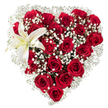 A richly hued, heart-shaped bouquet sits against a clean white backdrop, every inch dense with deep crimson roses whose velveteen petals curl in stages from tight buds to generously opened blooms. Tiny, starry clusters of white baby's breath (Gypsophila) are woven throughout the heart, their fine, cloud-like texture softening the intense red and creating delicate pockets of light that catch the eye. In the upper left curve a single, sculptural white lily unfurls its broad, pristine petals; a hint of creamy yellow near its throat and warm yellow-orange stamens add a quiet counterpoint to the surrounding reds. The roses' layered petals throw subtle shadows, giving the heart dimensionality, while the gypsophila's airy filigree provides a soft halo around the silhouette. The composition reads as both precise and overflowing - tightly arranged to hold the heart shape yet seemingly abundant, as if breath or music could lift a petal. Light on the white background is soft and diffuse, highlighting the tactile contrast between the roses' velvet and the lily's smooth, waxy surface. There is a faint imagined scent of classic rose perfume tempered by the lily's green-fresh edge, suggesting a bouquet meant for tender declarations or thoughtful remembrance. A local floral hand would prepare this for occasions across Notting Hill - from a quiet anniversary near Holland Park to a romantic surprise left by Portobello Road - always mindful of balance, texture, and heartfelt intent.