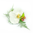 A quiet study in refined elegance: a single pristine white Phalaenopsis orchid sits at the heart of this wrist corsage or boutonniere, its broad, satiny petals opening like a small moonlit bloom. The orchid's throat reveals a soft wash of buttery yellow and warm gold with faint brown veining, lending depth to the otherwise pure white form and catching cool studio light in a subtle sheen. Fine sprays of asparagus fern fan out from beneath, their feathery, pale-green fronds creating an airy halo that lifts and lightens the composition, while a compact, lime-green chrysanthemum or similar filler nestles close to the base, adding a bright, almost chartreuse note of verdant texture. On one side, clusters of small reddish-pink hypericum-like berries introduce a gentle, natural punctuation - round, glossy and slightly warm against the cool white petals. The arrangement is intentionally asymmetrical yet balanced, compact enough to be pinned to a lapel or worn on the wrist, designed with negative space so each element breathes. The overall mood is serene and celebratory, like the hush before a wedding procession or the calm pride of a prom evening, evoking tactile impressions: the orchid's velvet-smooth petals, the fern's soft whisper, and the berries' slick coolness. I picture this kept cool after a short walk from Portobello Market to a Notting Hill doorway, the scent faintly green from foliage rather than overtly floral. The neutral white background in the photo magnifies every detail, making this a timeless, understated accent for moments that seek quiet luxury and thoughtful craftsmanship.