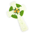 A three-dimensional Celtic cross, photographed from a slightly elevated angle against a crisp white background, crafted entirely from fresh flowers with the solemn care of a neighbourhood florist. The body of the cross is built from dense clusters of pure white spray chrysanthemums, their small, cushiony petals forming a plush, cloud-like surface that reads as quiet purity and soft reverence. Woven through that white base are bold threads of apple-green button chrysanthemums, their round, compact faces arranged to define the circular ring at the intersection of the arms and to punctuate alternating sections along the horizontal bars. At the very centre, where the arms meet, three fully opened orange roses gather as a warm focal point-golden-orange petals that glow against the cool white and fresh green, surrounded by a few dark green fern-like sprigs that lift the roses and add gentle contrast. The composition has a tactile richness: the firm, button texture of the green blooms, the feathery softness of the white sprays, and the velvety warmth of the roses. Subtle soft lighting sculpts the three-dimensional form, casting delicate shadows that emphasise the cross's depth and craftsmanship. This arrangement reads as a deeply respectful funeral or memorial tribute, evoking Irish or Celtic heritage through its circular motif and colour echoes of green, white and warm gold. As a local florist familiar with Notting Hill and nearby Portobello Road, I picture this piece placed at a chapel service or family remembrance in Holland Park, offered for careful delivery across the area to honour a loved one with dignity and heartfelt sympathy.